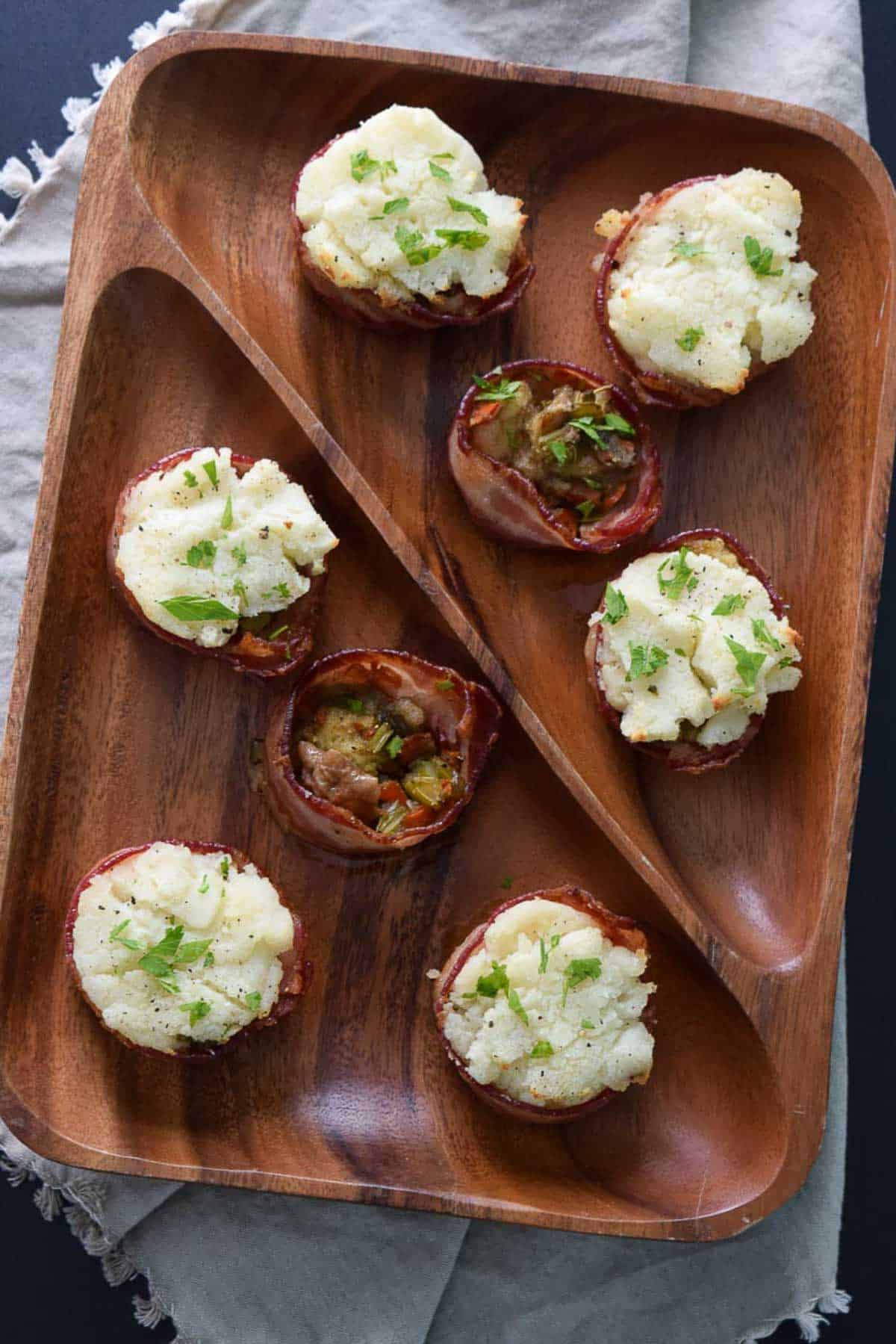 Overhead view of bacon cups topped with mashed potatoes and parsley 