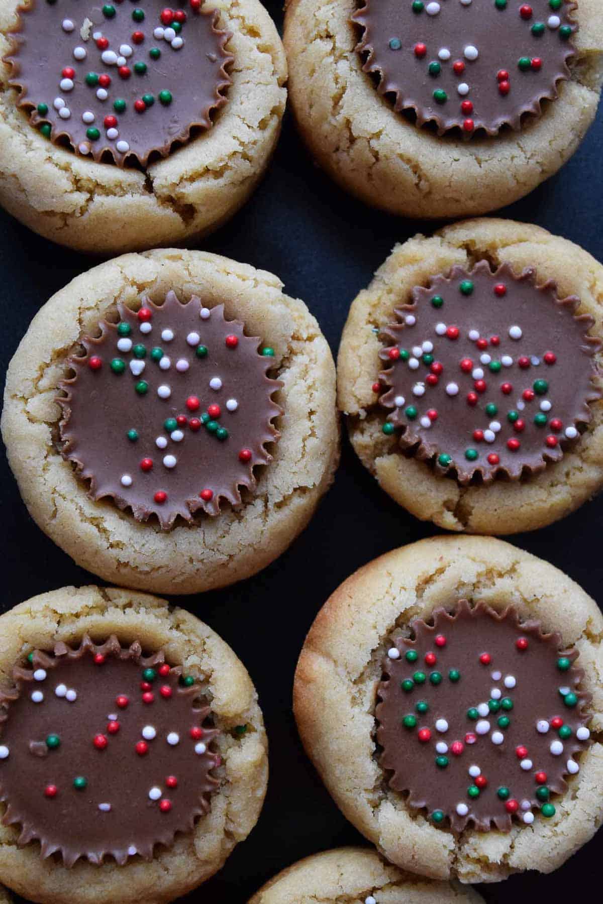 close up overhead view of peanut butter cup cookies topped with sprinkles