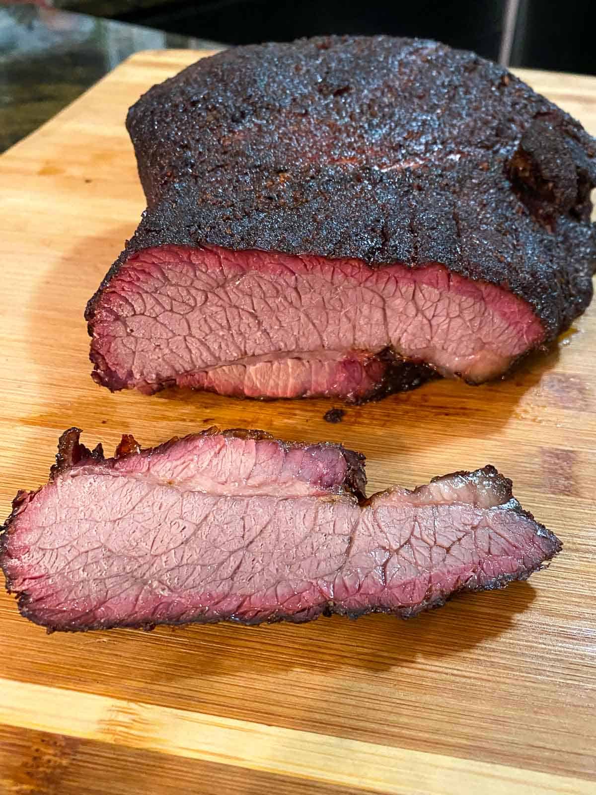 Finished brisket sliced on cutting board up close