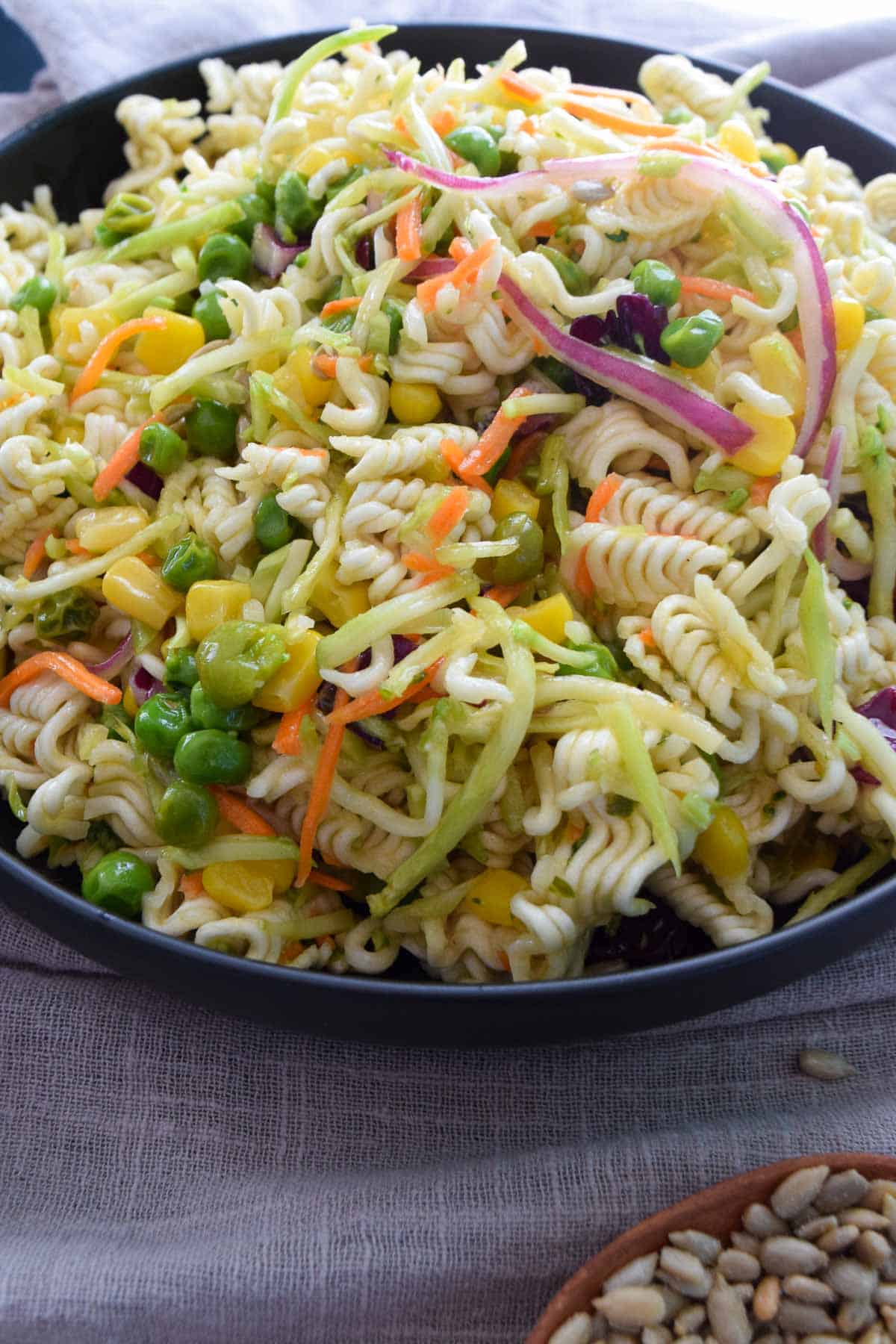 close up view of dump and done ramen salad served in black bowl